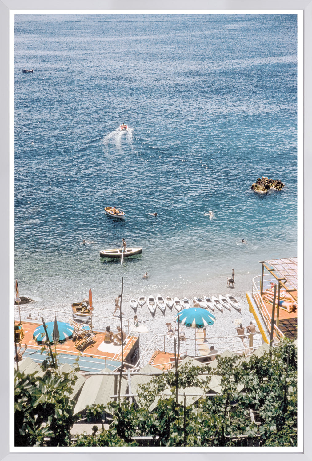 Toni Frissell – Capri II, C. 1959, beach scene with boats and umbrellas, clear blue water