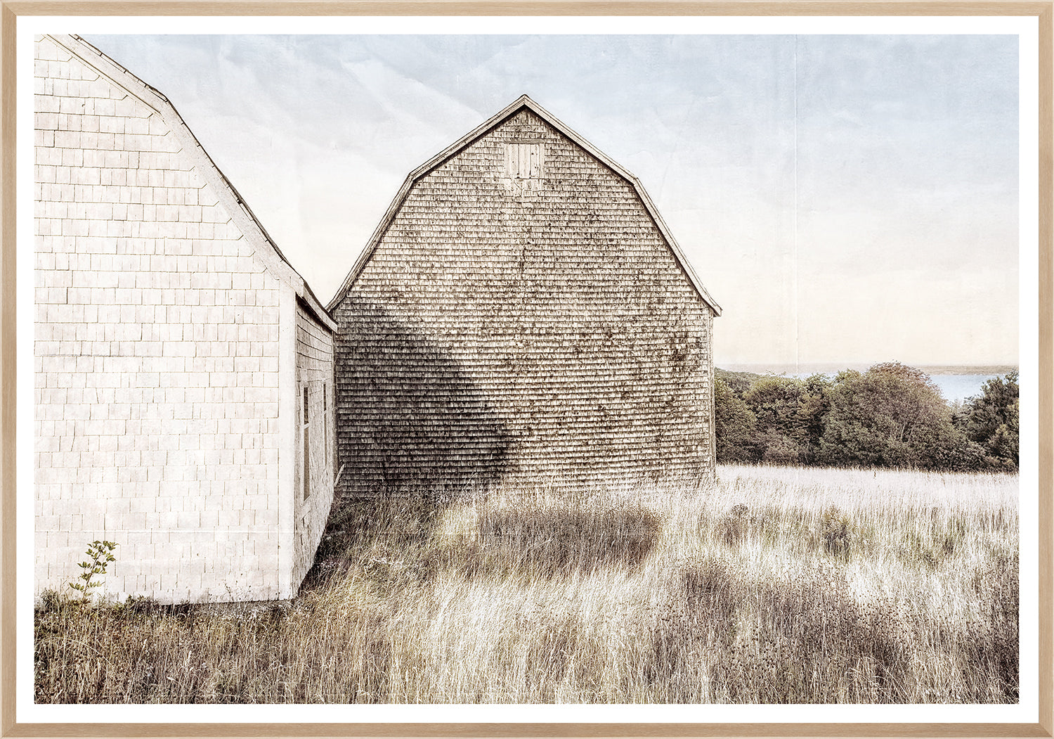 Maritime View wall art featuring two weathered barn structures against a soft sky.