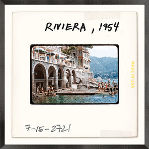 Toni Frissell Slides, Riviera, 1954 wall art featuring a vintage seaside scene with people swimming.