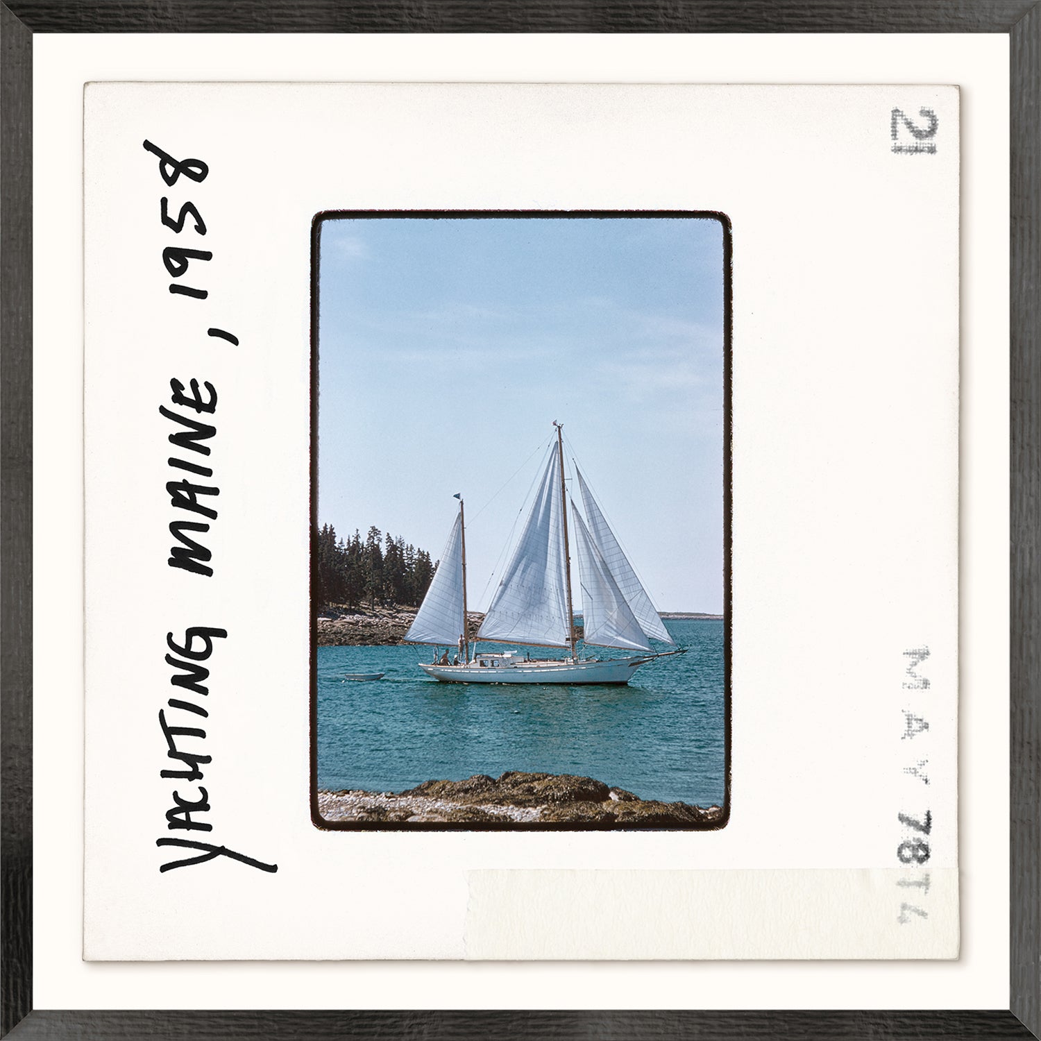 Toni Frissell Slides, Yachting Maine, 1958 featuring a sailboat on blue water with trees in the background, framed.