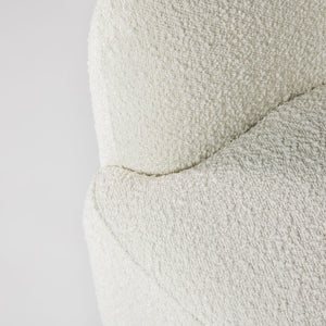 Close-up of a textured white fabric on a light gray background