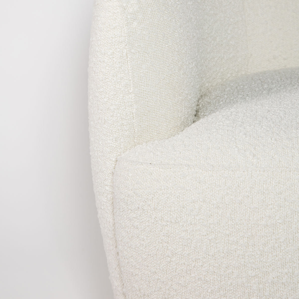 Close-up of a textured white cushion on a light gray background