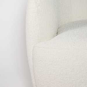 Close-up of a textured white cushion on a light gray background