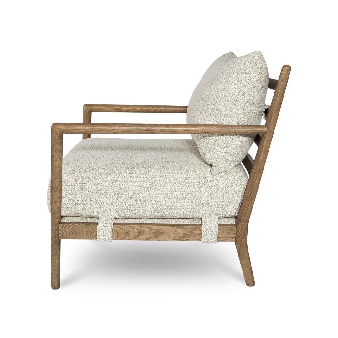 Chair with wooden frame and beige cushion on a white background