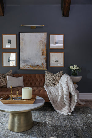 Berkshire Picture Light 37" in aged brass styled in a reading room for warm, layered light at Laurie Yapp Home.