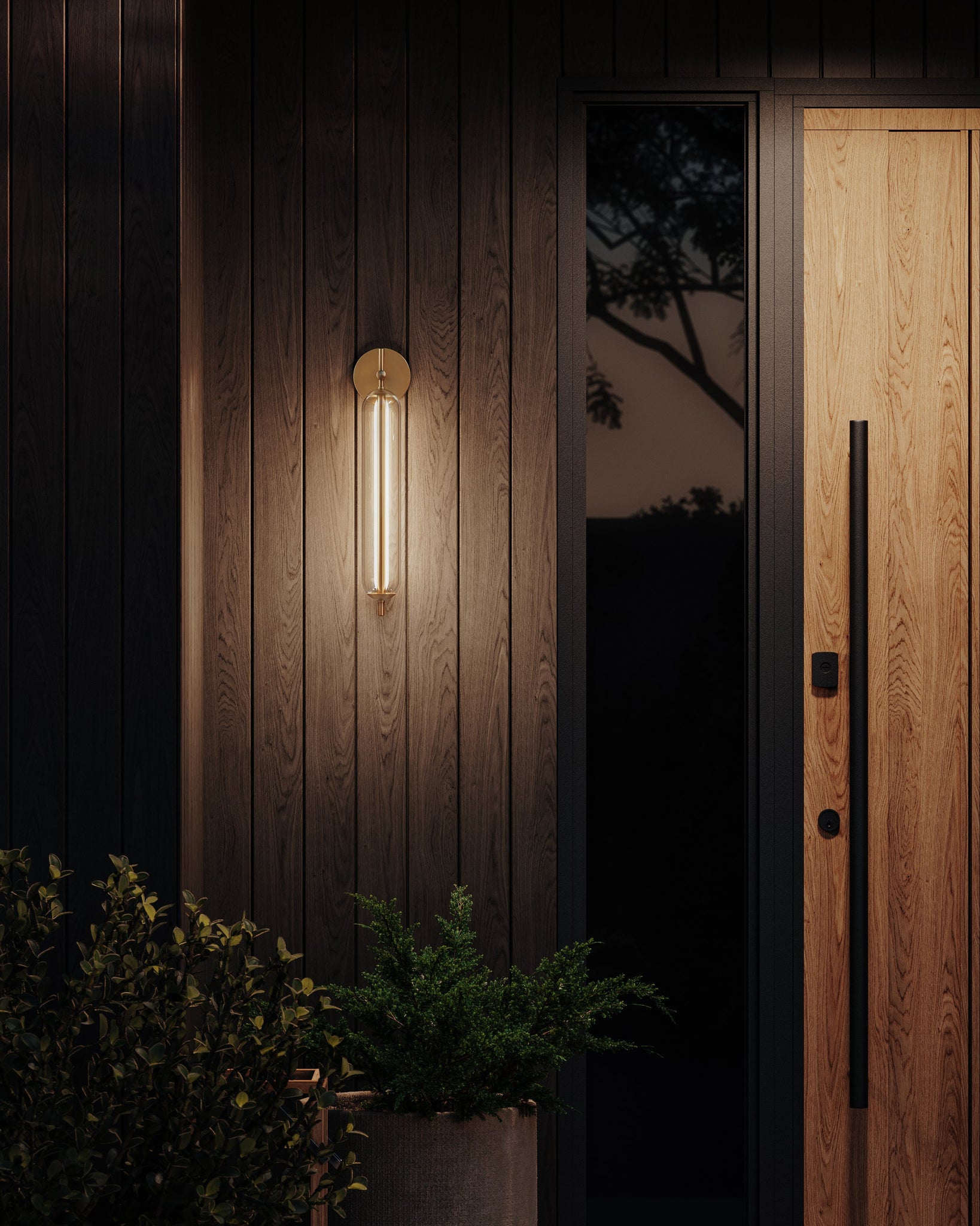 Blaze Exterior Wall Sconce 4.5" x 21.25" styled in a warmly lit hallway for warm, layered light at Laurie Yapp Home.