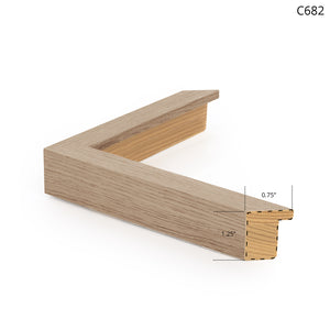 Wooden picture frame with a light oak finish, showcasing a corner view.