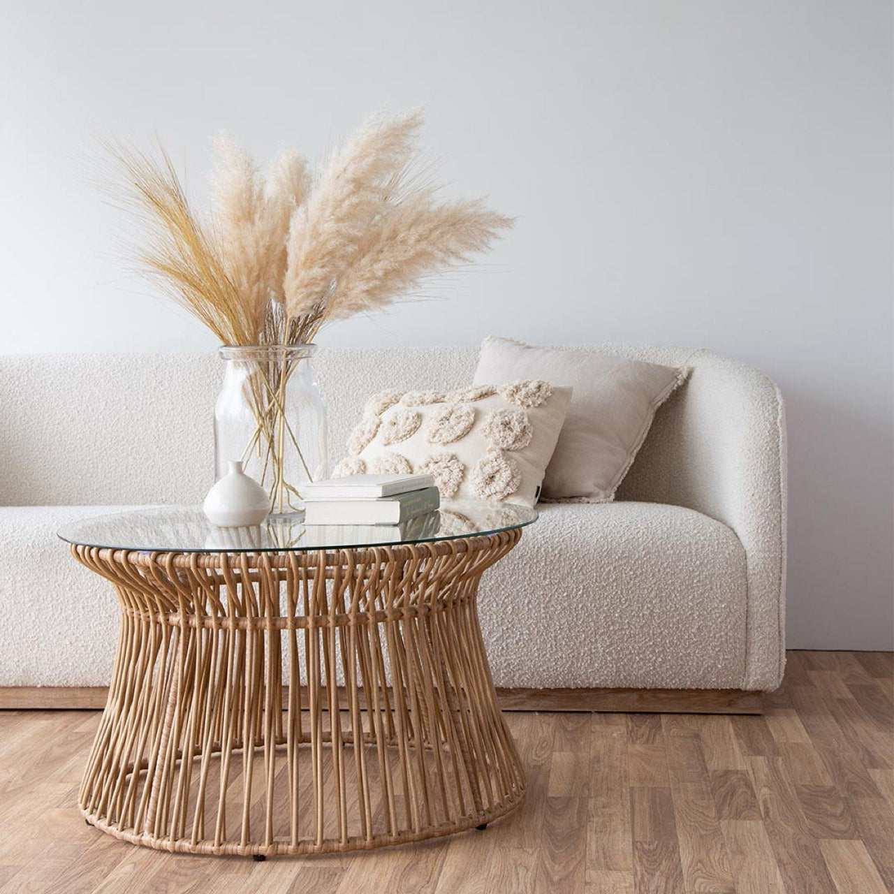 Wicker coffee table with glass top on a white background