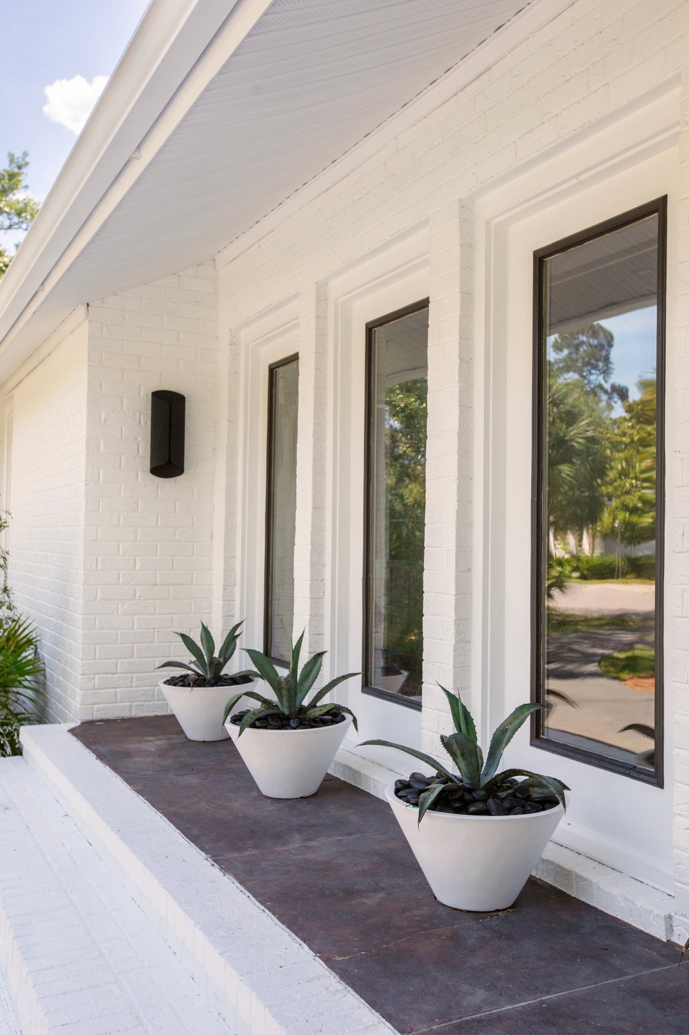 Cole Exterior Wall Sconce 7.75" styled in a curated living room for warm, layered light at Laurie Yapp Home.