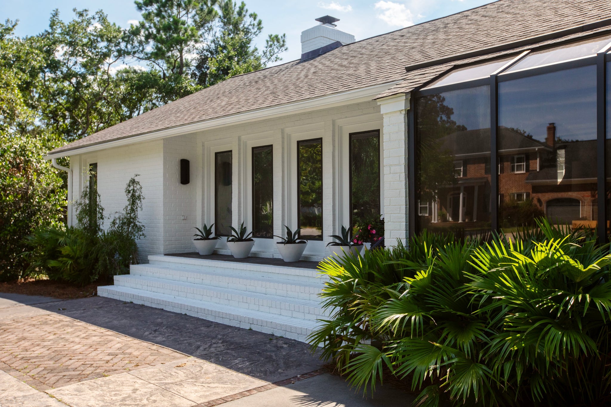 Cole Exterior Wall Sconce 7.75" styled in a modern bathroom for warm, layered light at Laurie Yapp Home.
