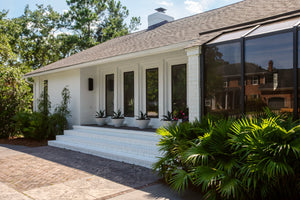 Cole Exterior Wall Sconce 7.75" styled in a modern bathroom for warm, layered light at Laurie Yapp Home.