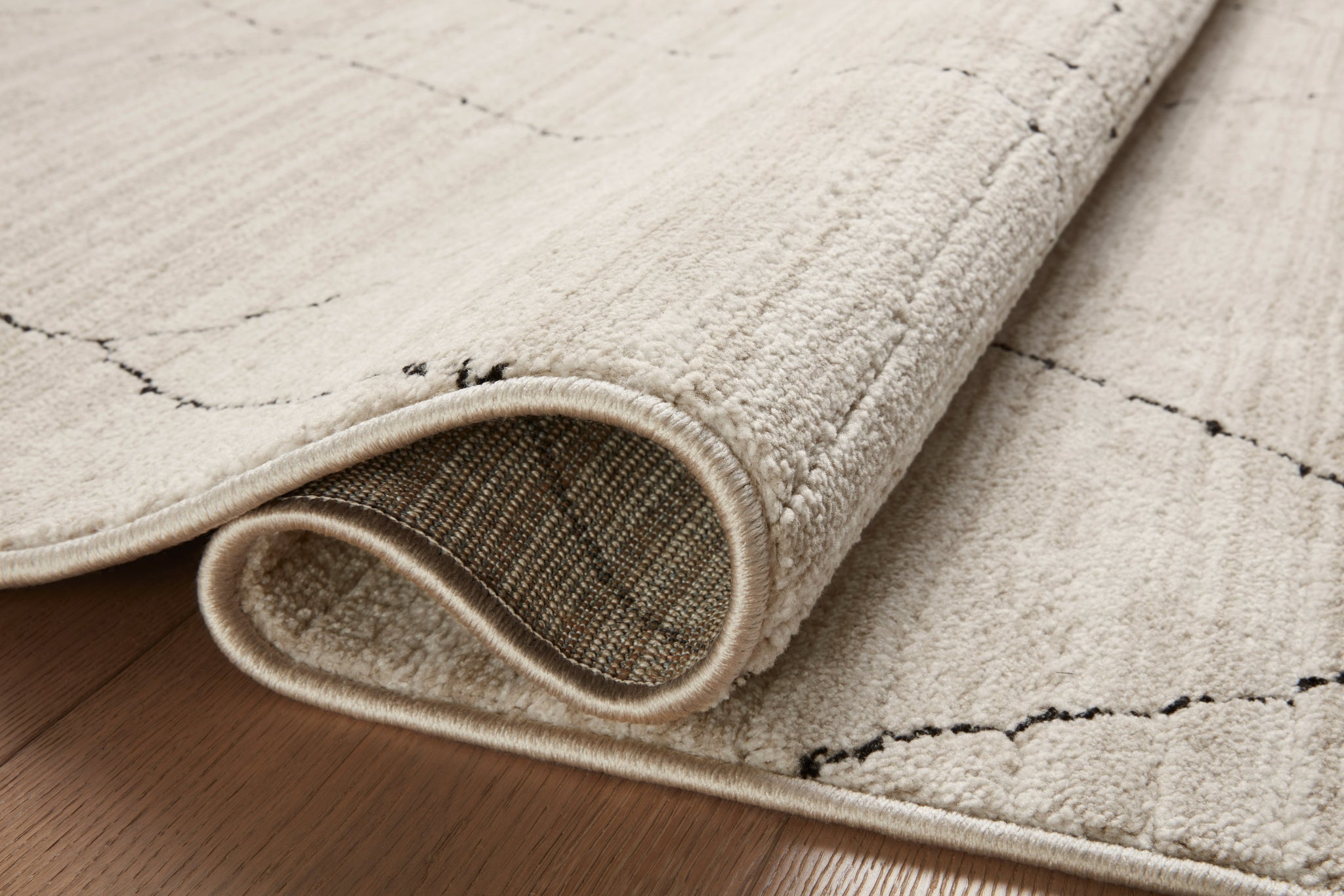 detail view of Darby Sand / Charcoal luxury Rug