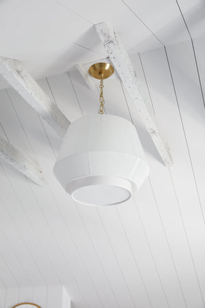 Debi Pendant 18" in aged brass styled in a welcoming entryway for warm, layered light at Laurie Yapp Home.