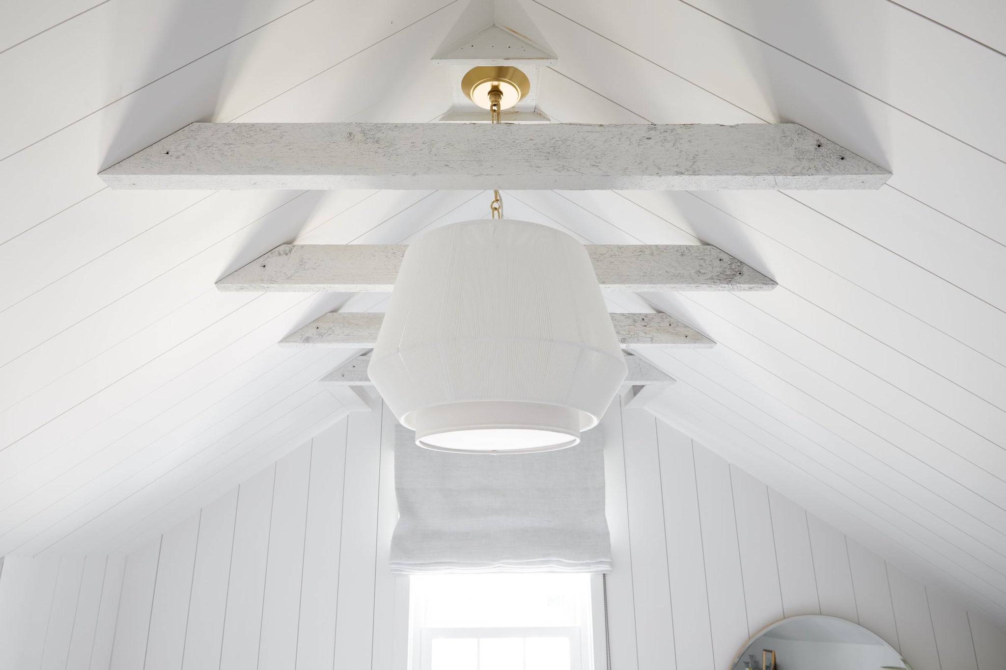 Debi Pendant 18" in aged brass styled in a welcoming entryway for warm, layered light at Laurie Yapp Home.