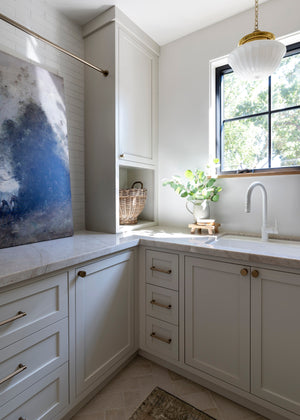 Dutchess Pendant 12" in aged brass styled in an elegant dining room for warm, layered light at Laurie Yapp Home.