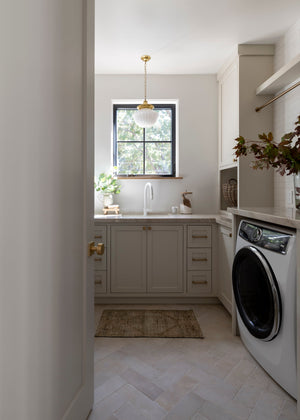 Dutchess Pendant 12" in aged brass styled in a bright kitchen for warm, layered light at Laurie Yapp Home.