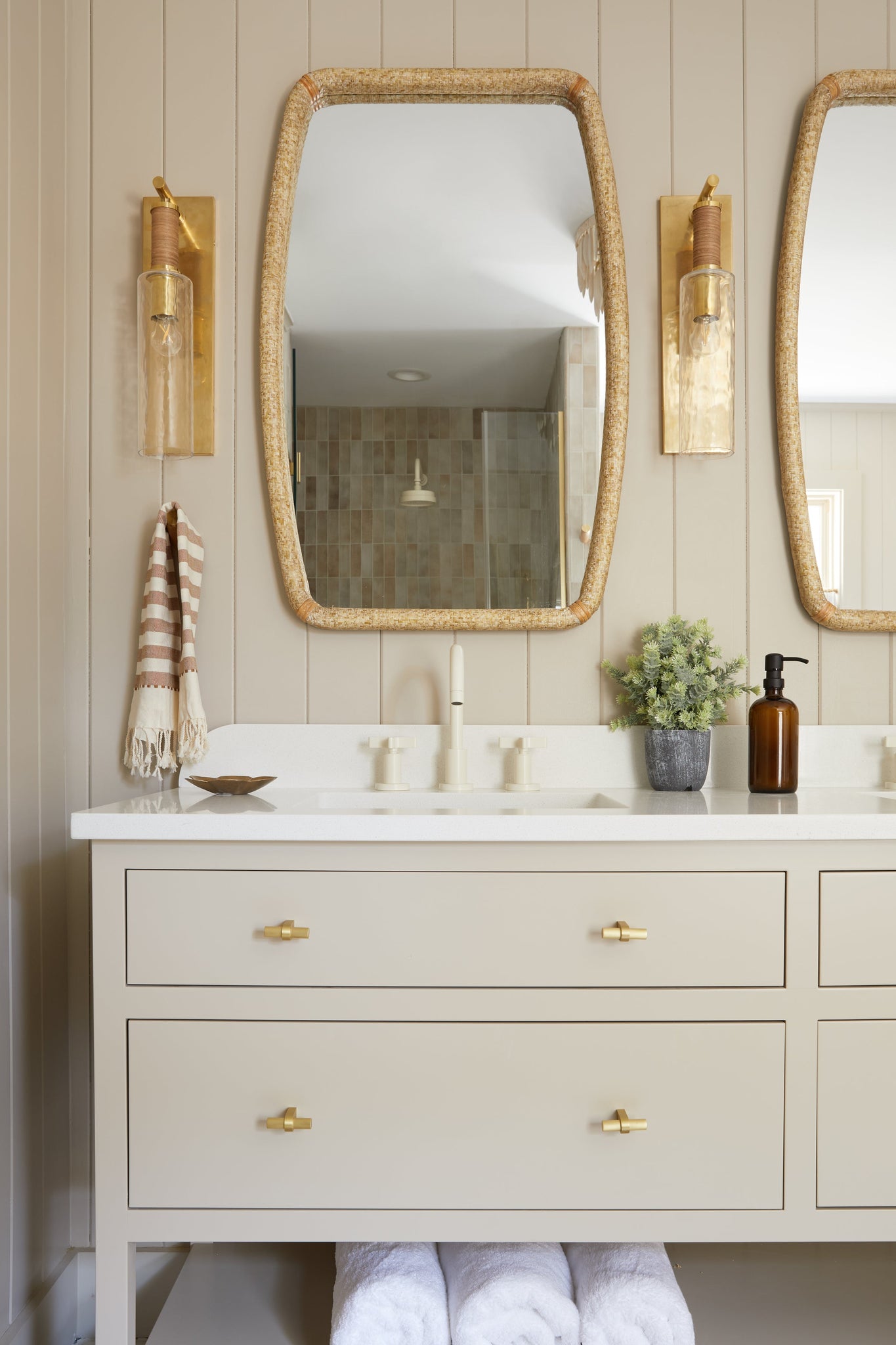 Eastchester Wall Sconce in aged brass styled in a warmly lit hallway for warm, layered light at Laurie Yapp Home.
