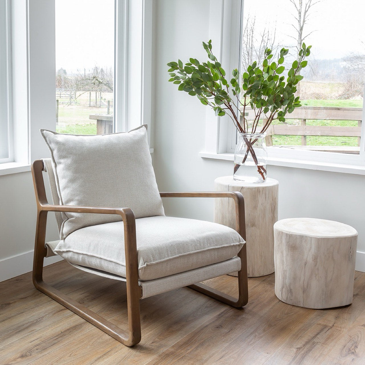 Chair with white cushions and wooden frame on a white background
