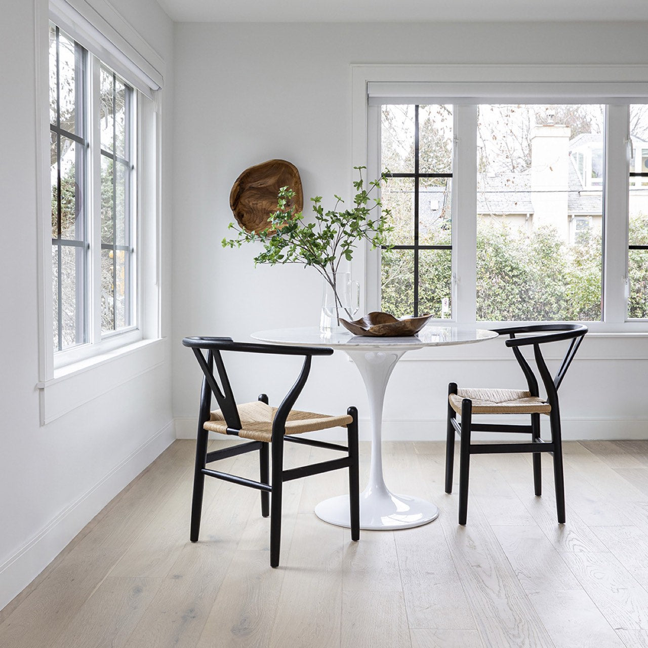 Round marble table with a white base on a white background