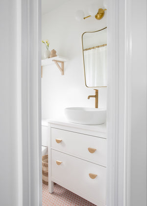 Fleming Bath And Vanity 20.75" in aged brass styled in a powder room for warm, layered light at Laurie Yapp Home.