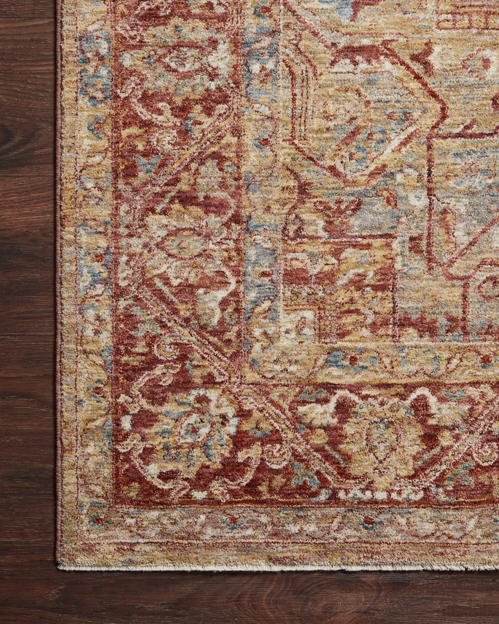 side view of Gaia Gold / Brick luxury Rug