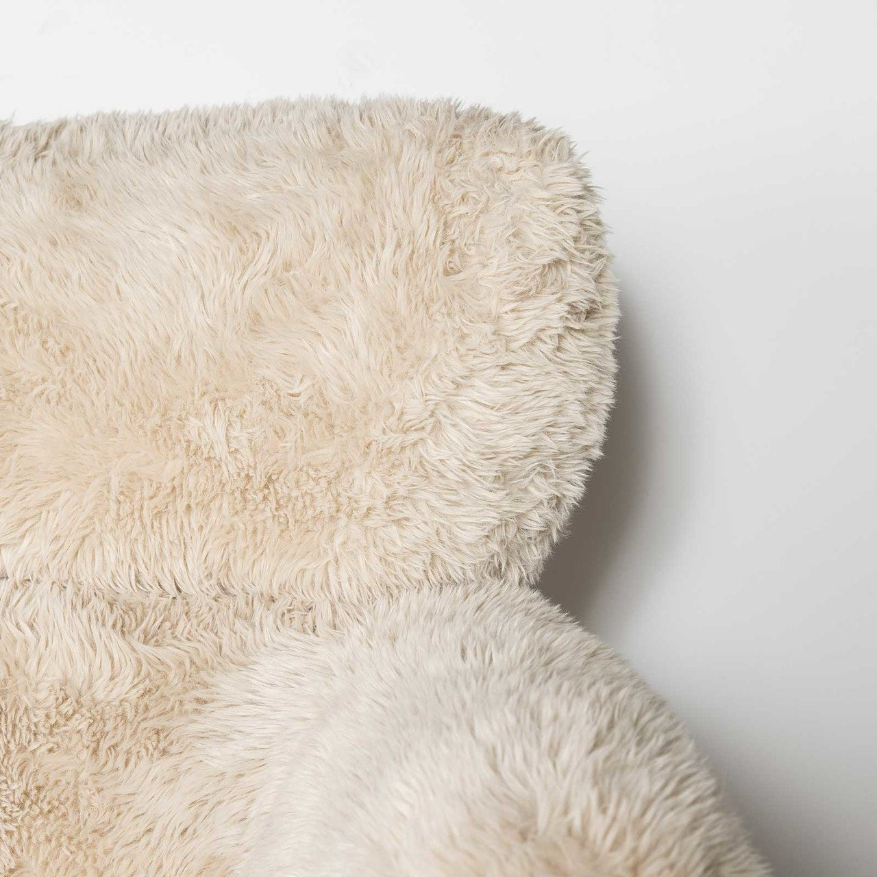 Beige fluffy armchair on a white background