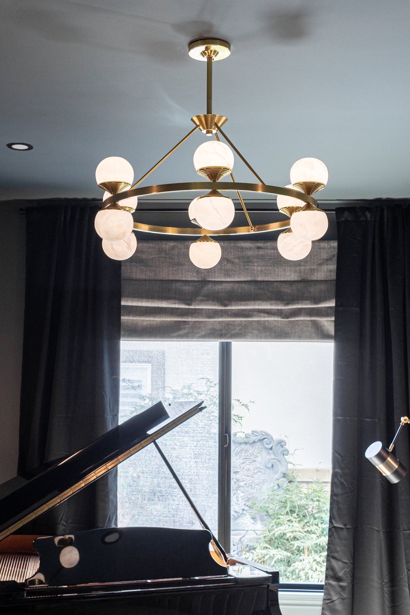 Grafton Chandelier 34" in aged brass styled in a formal living room for warm, layered light at Laurie Yapp Home.