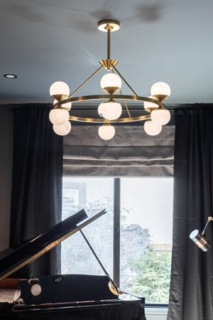Grafton Chandelier 34" in aged brass styled in a formal living room for warm, layered light at Laurie Yapp Home.