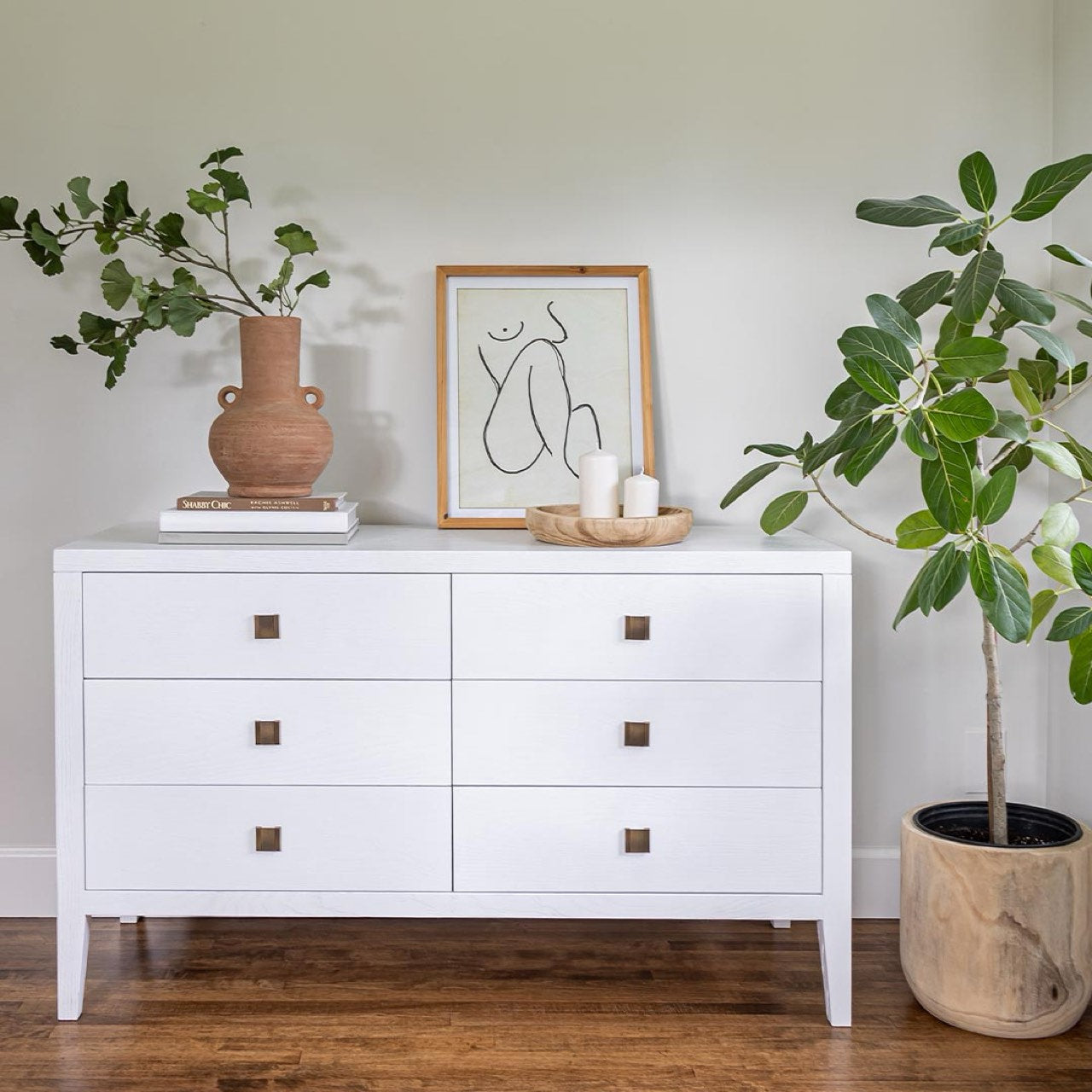 White dresser with gold accents on a white background