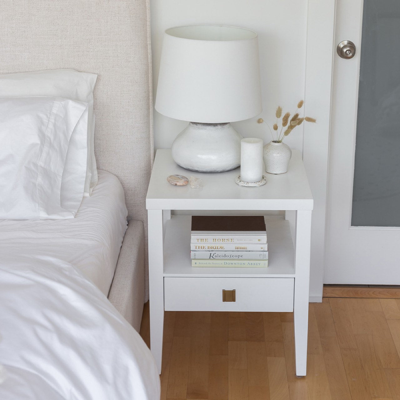 White nightstand with a drawer on a white background