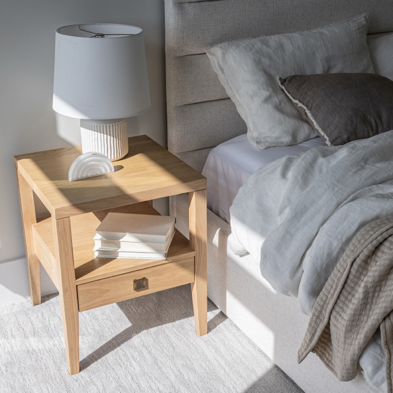 Wooden side table with a drawer on a white background