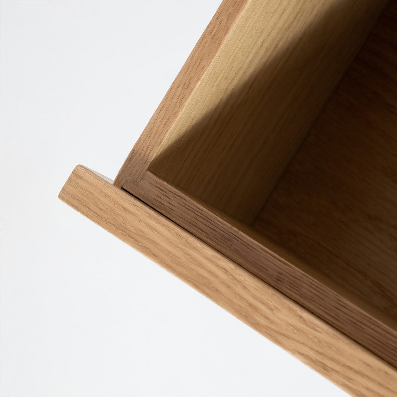 Wooden dresser with six drawers on a white background