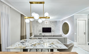 Dunkirk Chandelier 30" in aged brass styled in an elegant dining room for warm, layered light at Laurie Yapp Home.