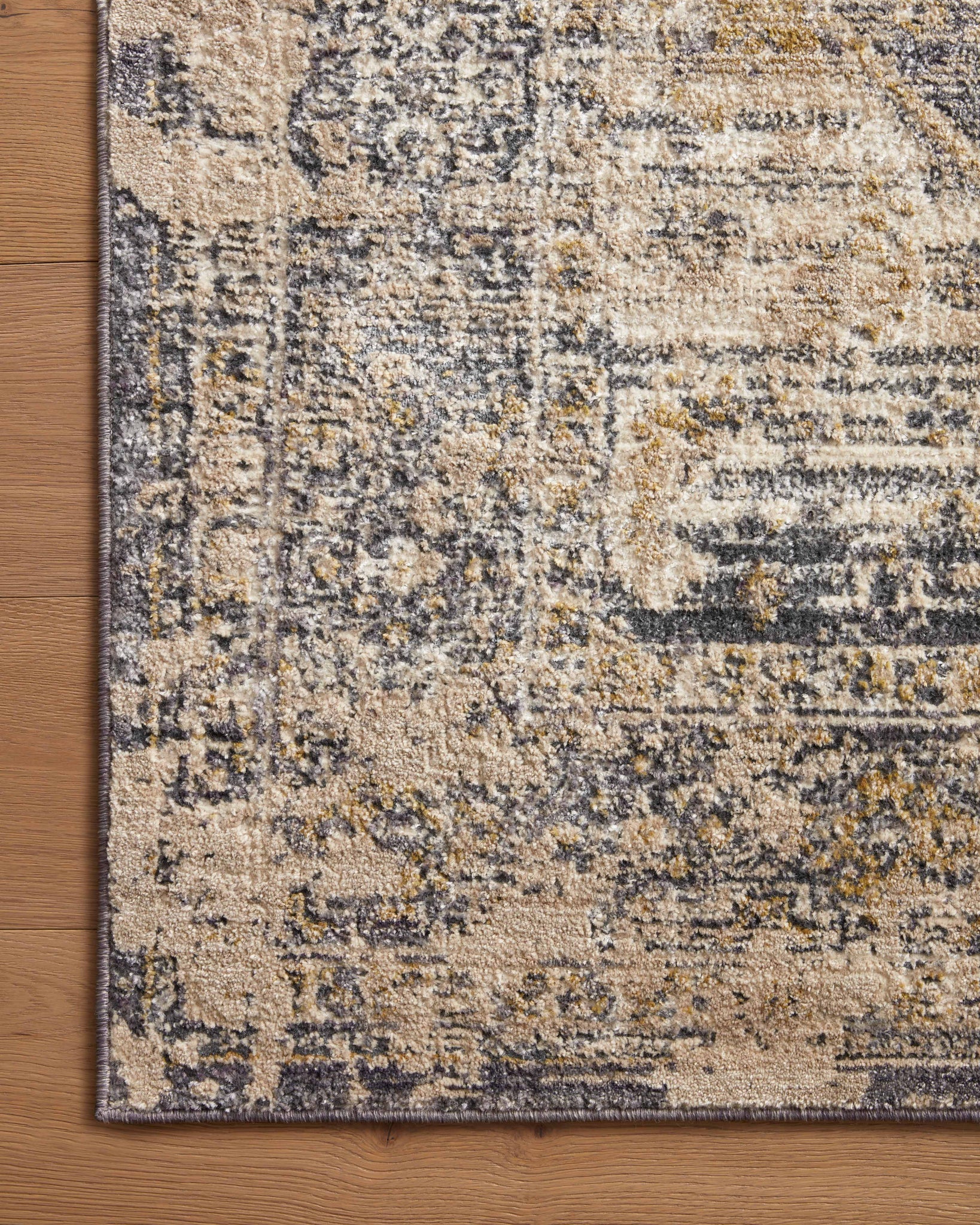 side view of Indra Charcoal / Natural luxury Rug