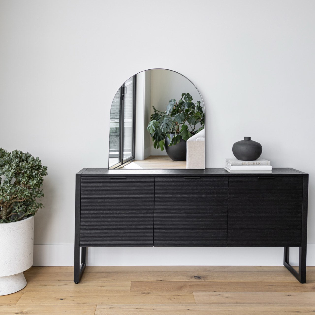Black sideboard with minimalist design on a white background