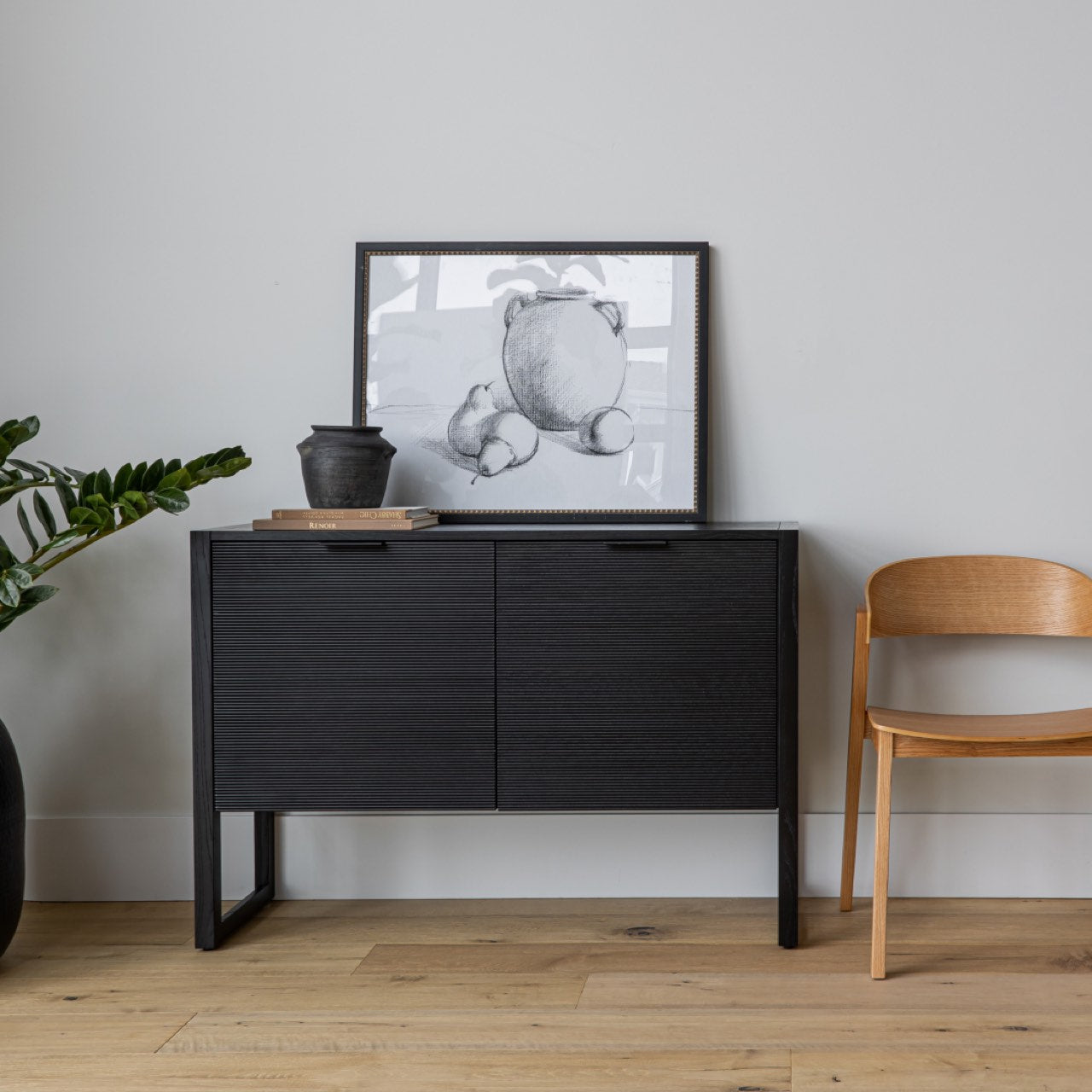 Black sideboard with two doors on a white background
