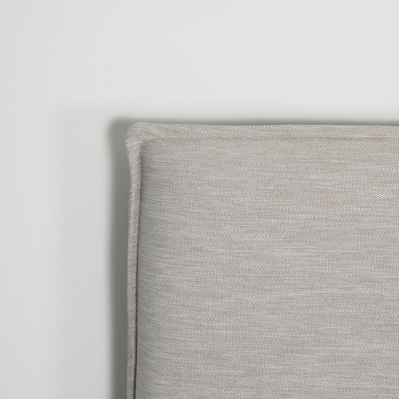 Gray upholstered bed with white mattress on a white background