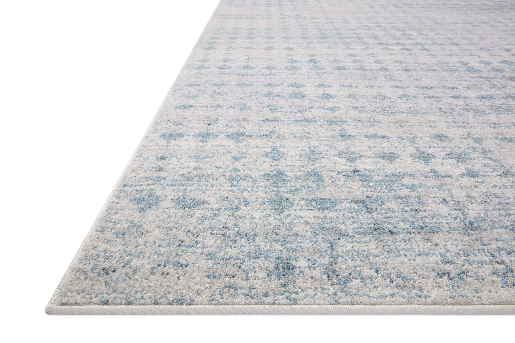 side view of Kamala Sky / Dove luxury Rug