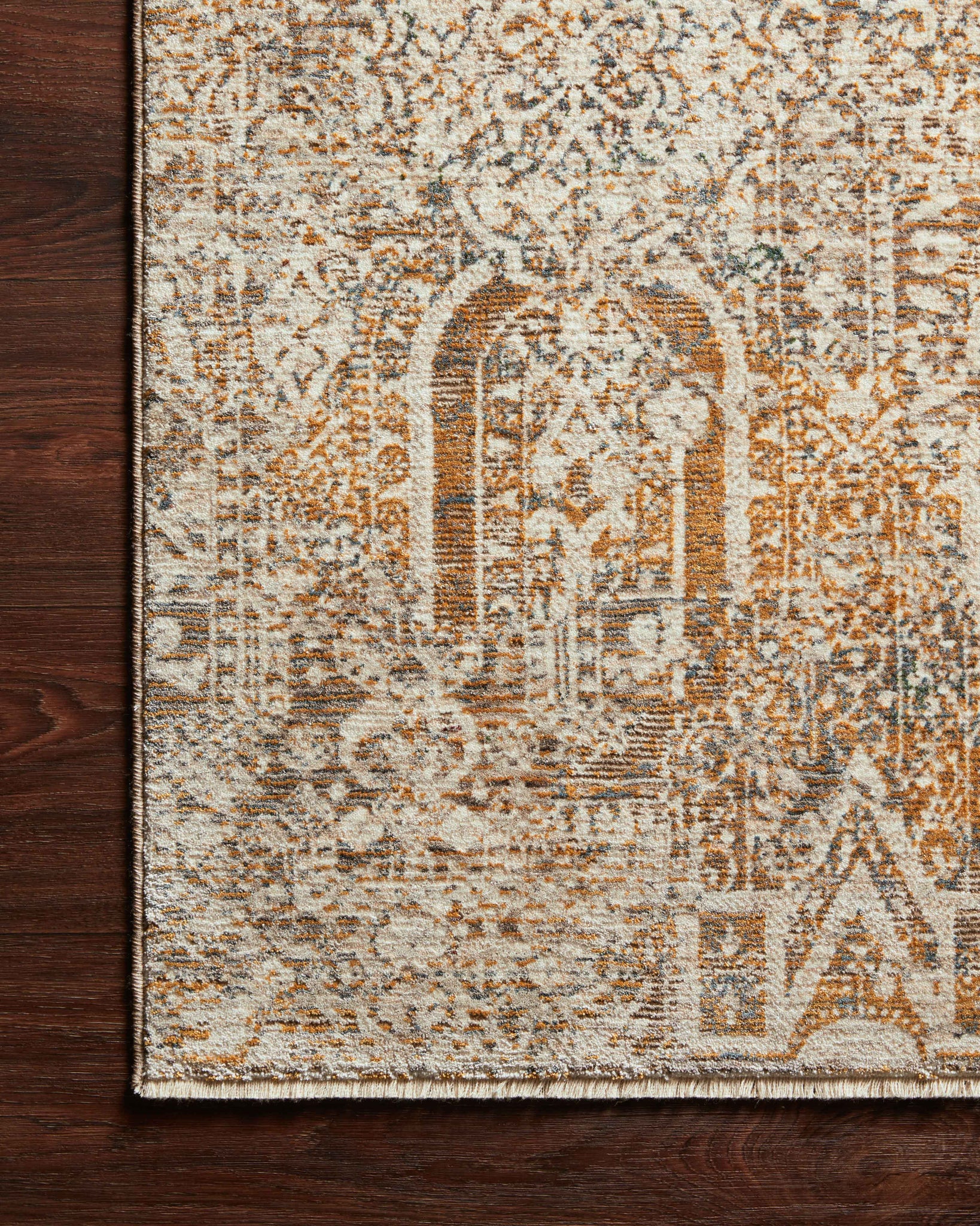side view of Lourdes Ivory / Orange luxury Rug