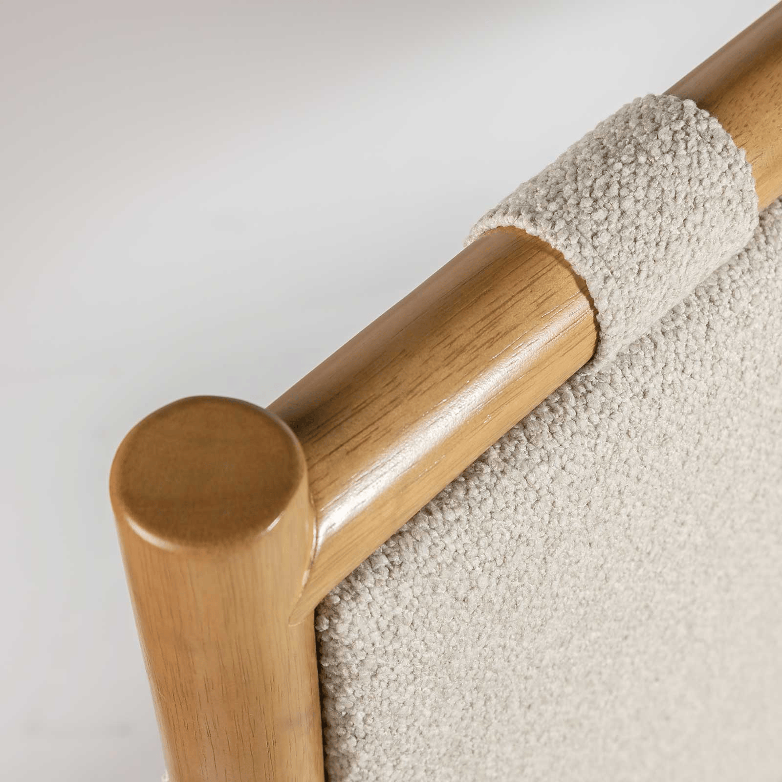 Wooden bed with white mattress and decorative pillows on a white background