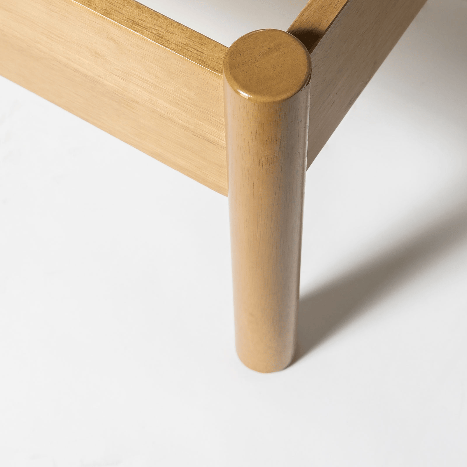 Close-up of a wooden leg on a white background