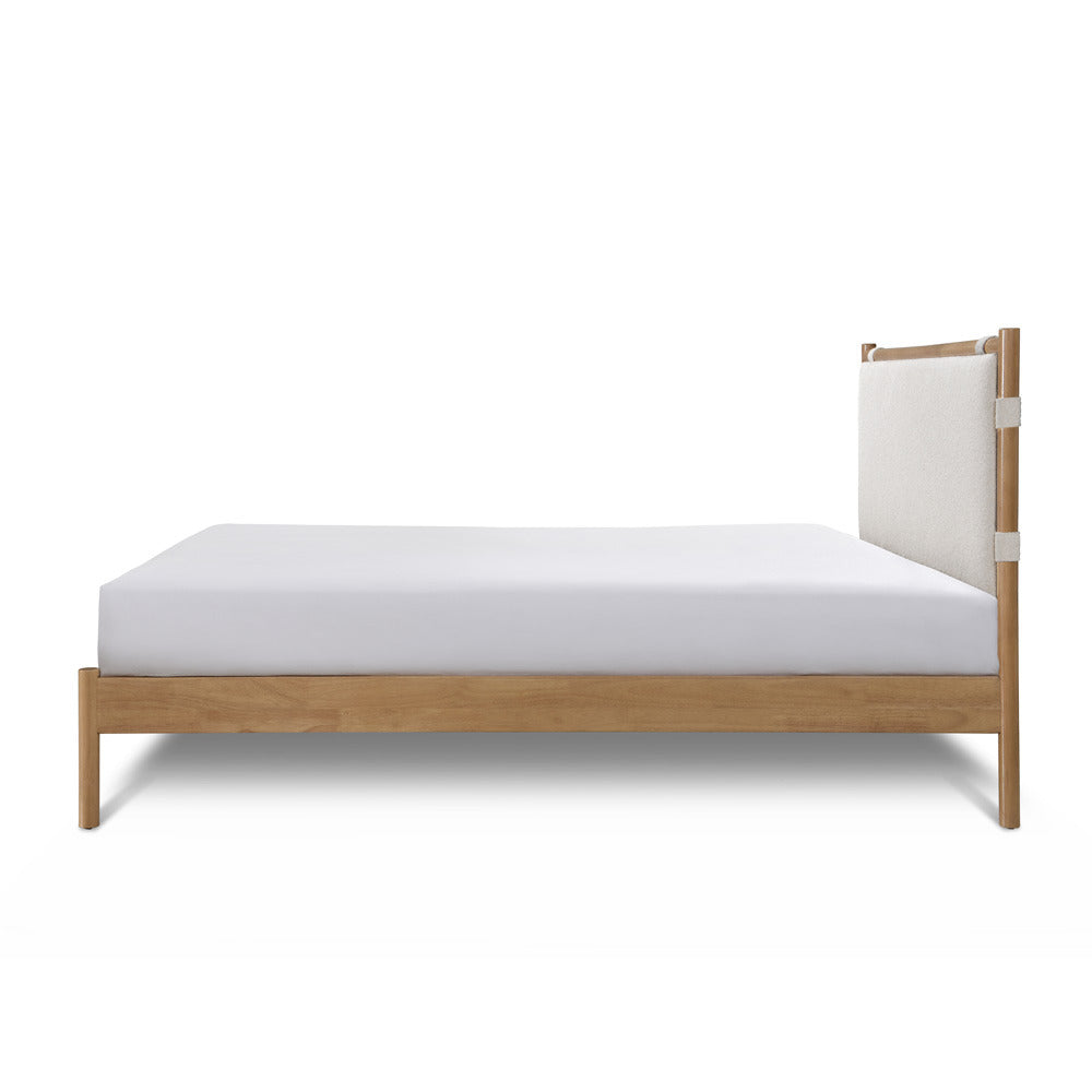 Wooden bed frame with white mattress on a white background