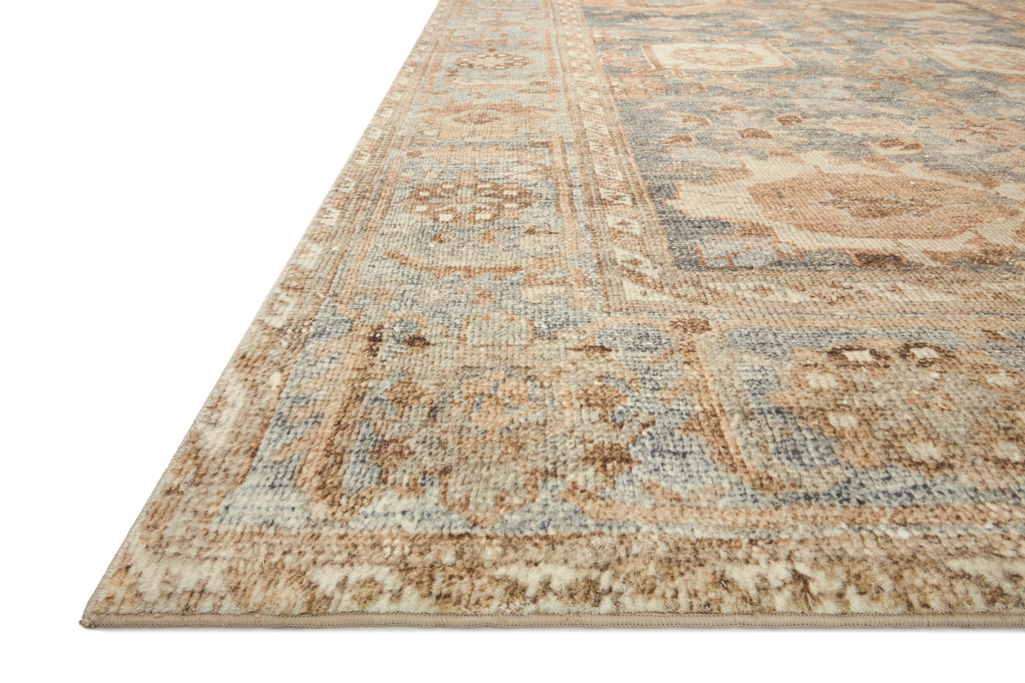 side view of Margot Ocean / Spice luxury Rug