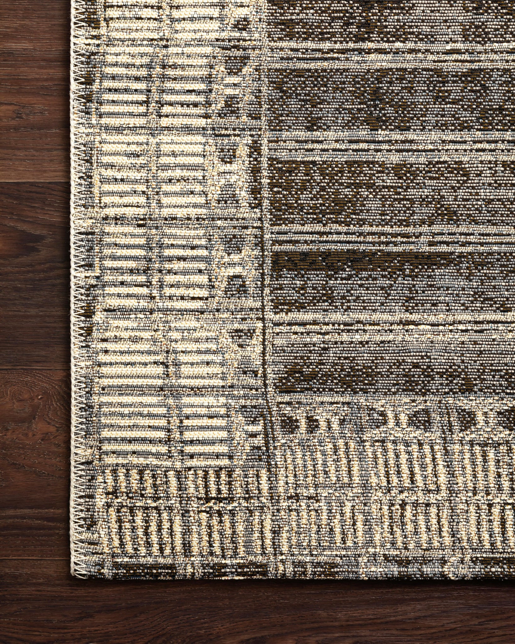 detail view of Mika Charcoal / Ivory luxury Rug