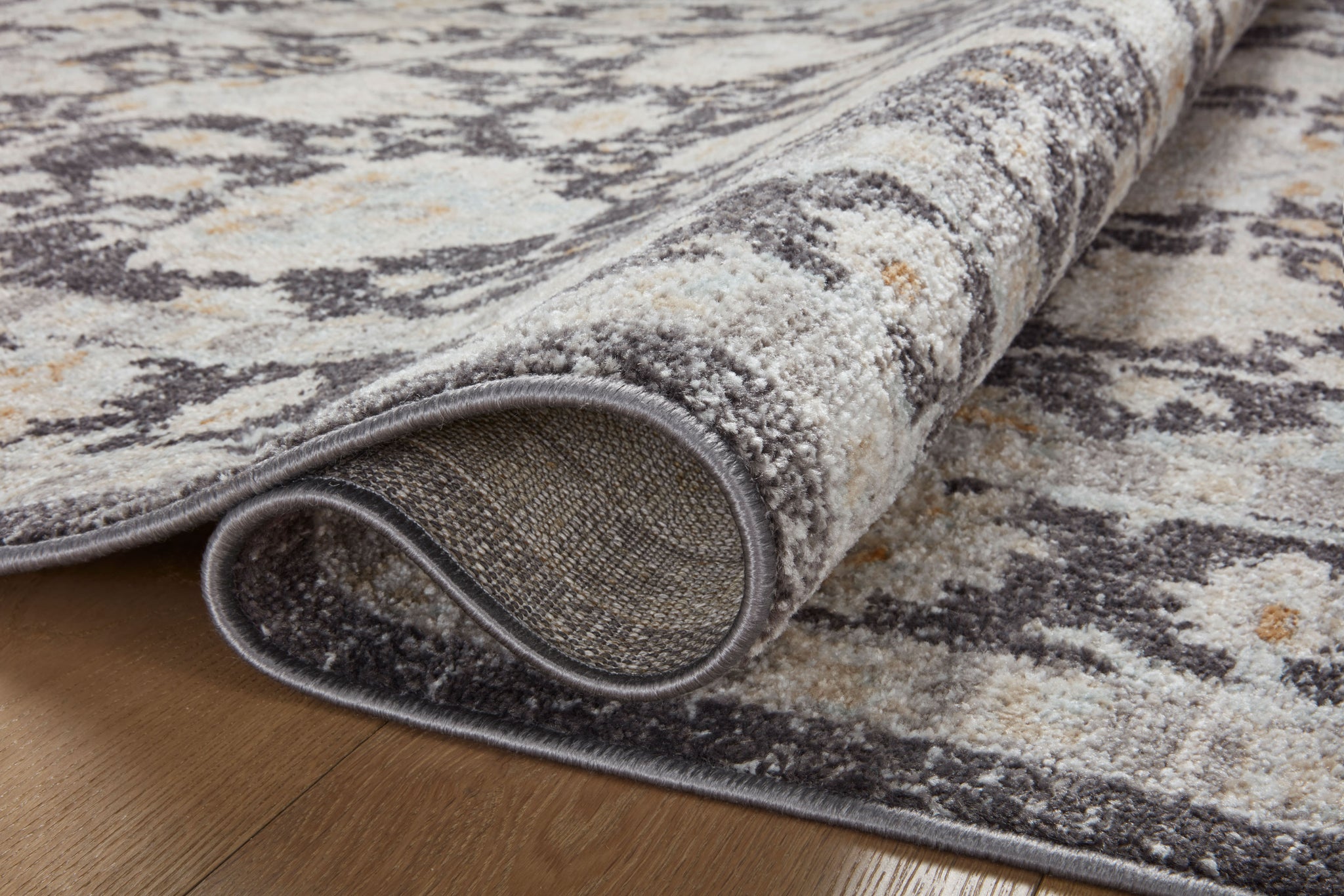 side view of Monroe Charcoal / Natural luxury Rug