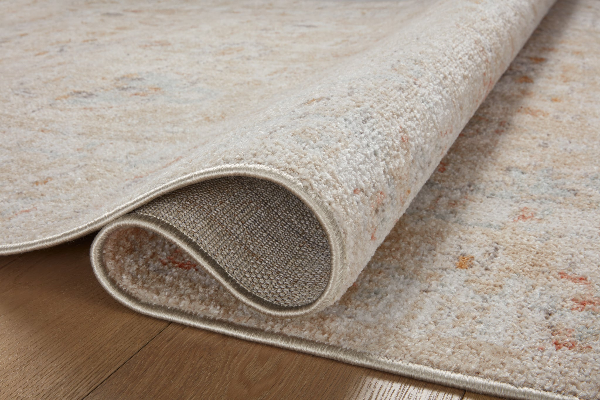 side view of Monroe Sand / Sunrise luxury Rug