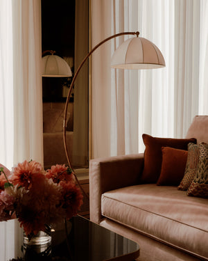 Montague Floor Lamp in aged brass styled in a bedroom for warm, layered light at Laurie Yapp Home.