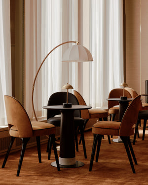 Montague Floor Lamp in aged brass styled in a reading nook for warm, layered light at Laurie Yapp Home.