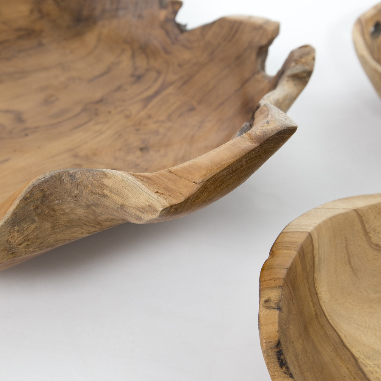 Two wooden bowls with natural edge design on a white background