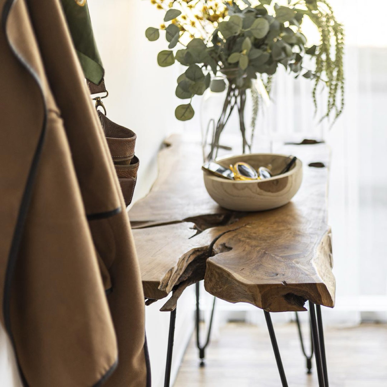 Wooden table with a bowl and plants in a home setting